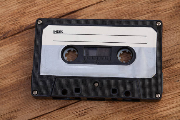 istock Vintage compact cassette on wooden table. 2204031697
