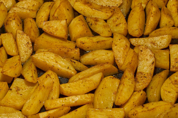 istock Baked potato slices with seasoning mixture. 2204034049