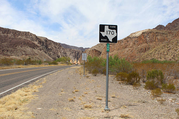 istock Texas State Farm Road 170 with cliffs and teepees in the background at Big Bend Ranch State Park 2204035452