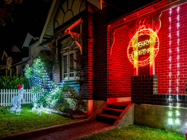Christmas fairy tale house with warm glow windows at nighttime city street, symbolizes spirit of winter season emanating warmth and joy to all who pass by festive city street on New Year eve
