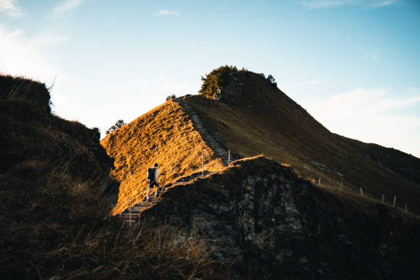 istock Young man hikes on mountain ridge in autumn 2204035649