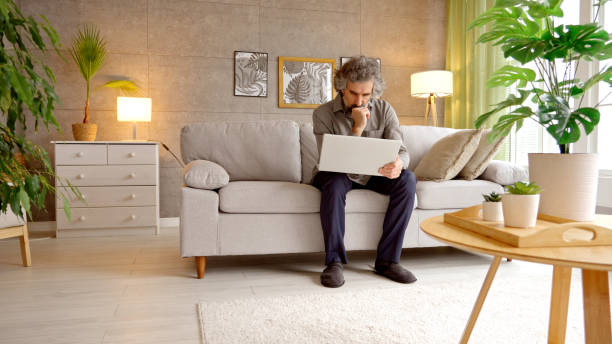 istock Mature Businessman Working From Home. Freelancer Life & Telecommuting 2204036846