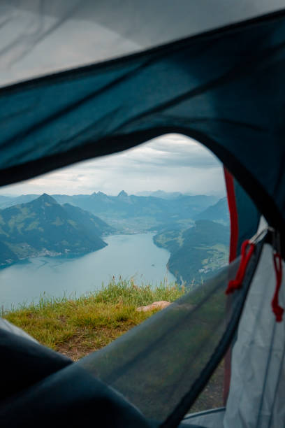 istock View through tent to lake and mountains below 2204038132