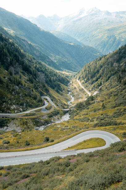 istock Elevated view of curving mountain road above valley 2204038346