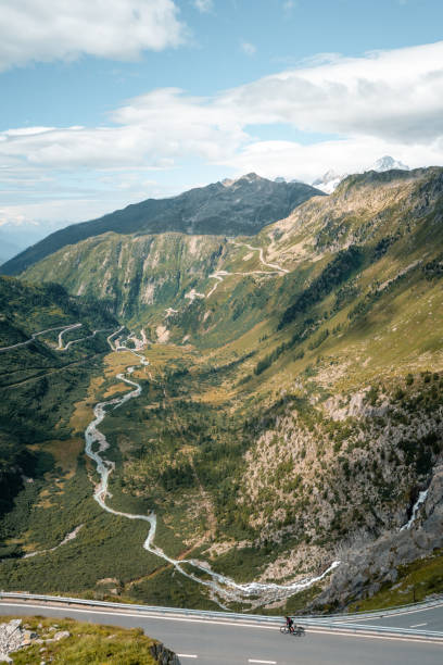 istock Road biker rides up high mountain pass 2204038359
