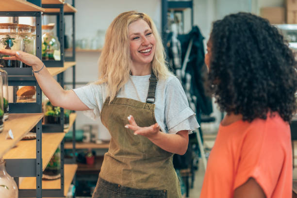 istock Beautiful flower shop owner  with client 2204046658