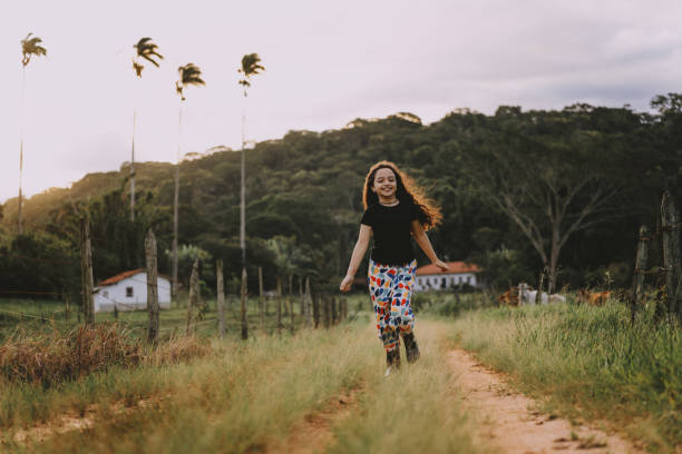 Little girl having fun running on the farm path