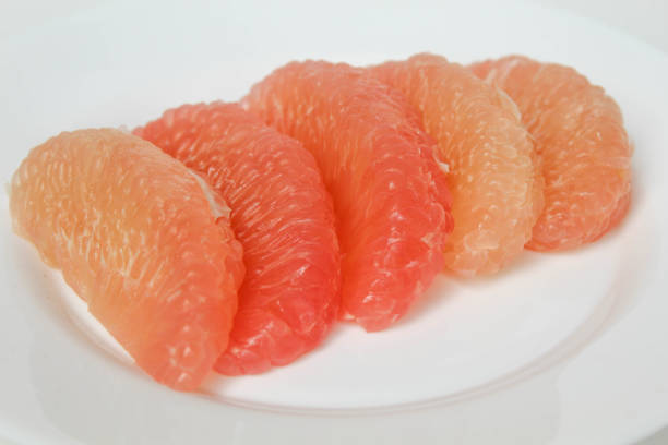 Fresh slice of red Grapefruit. Isolated on white background.