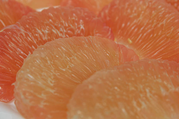 Closed up view of peeled pomelo fruit, isolated on white background