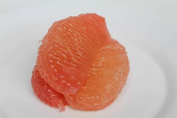 Slices of white and red Grapefruits isolated on white background.