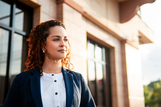 istock Confident hispanic businesswoman planning future outside office building 2204059676