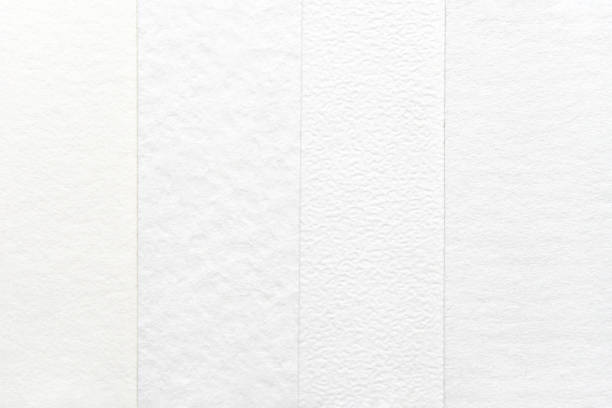 istock Close-up of textured white paper sheets with various patterns and subtle 2204059697