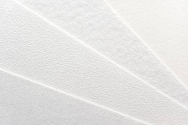 Close-up of textured white paper sheets arranged in a fan pattern
