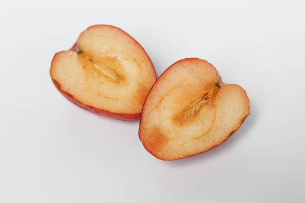 Freshly sliced apple showcasing its juicy, crisp texture and vibrant colors on a minimalist gray plate, ideal for healthy eating concepts and food photography.