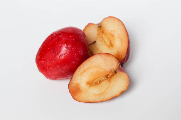 Halved strawberry apples or cherry apple, isolated on white background
