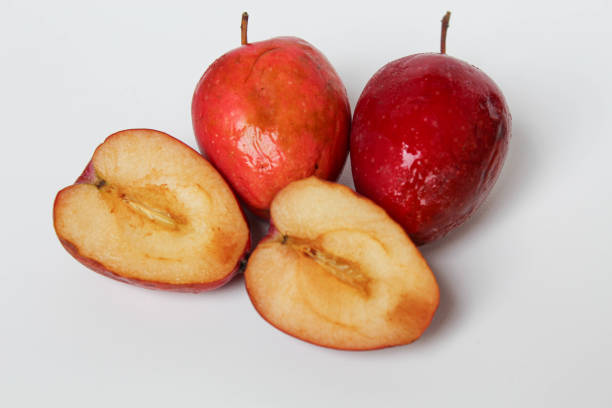 Halved strawberry apples or cherry apple, isolated on white background