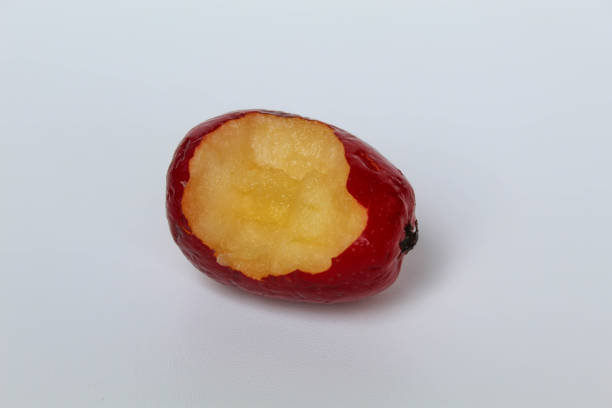 Bitten of strawberry apples or cherry apple, isolated on white background