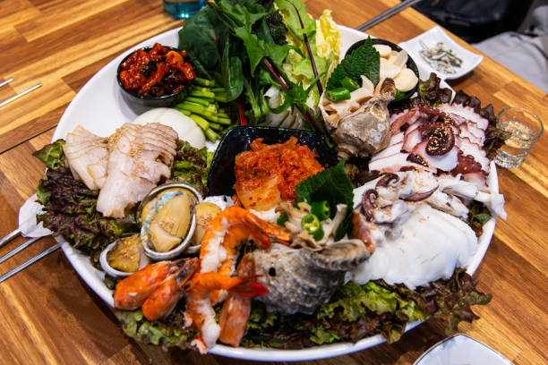 A beautifully arranged bowl holds a selection of appetizers, artistically presented with various toppings and garnishes. The artistic touch and contrast of colors make this an eye-catching culinary display, perfect for gourmet settings, celebrations, or fine dining environments, showcasing sophistication and taste.