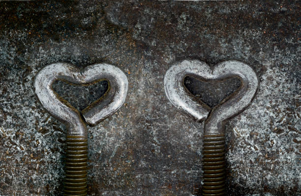 two steel handles shaped heart on a steel background