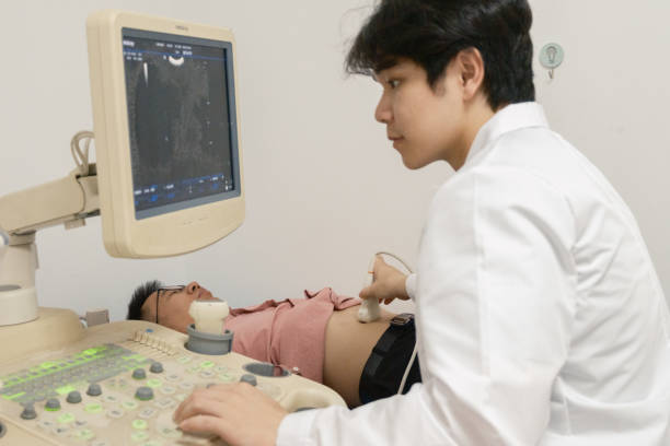 istock Doctor performs B-ultrasound scan on patient 2204070629