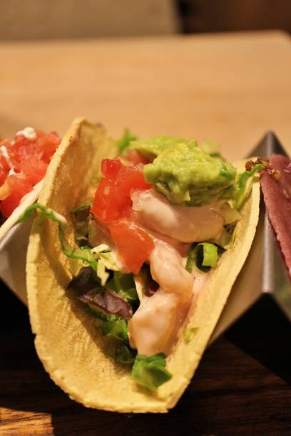 istock Tex-Mex cuisine (Mexican cuisine): shrimp and avocado taco 2204072179