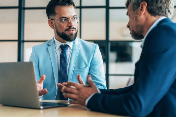istock Two business coworkers talking 2204072752