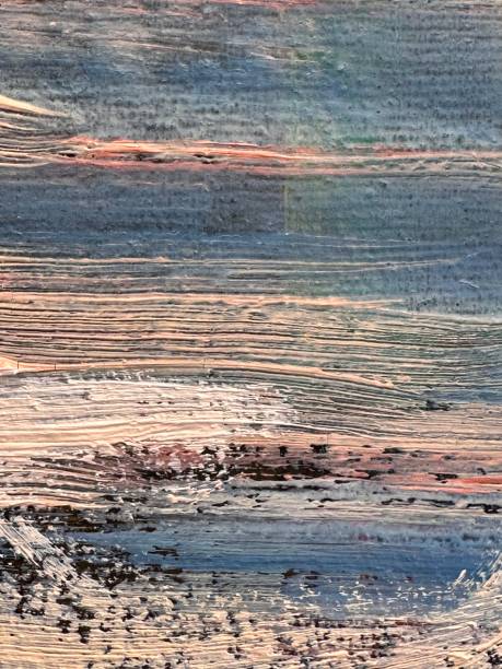 istock A textured surface with thick strokes of paint creating a wavy relief. The combination of blue, gray, beige and pink shades adds the effect of an abstract landscape or a worn surface. 2204075011