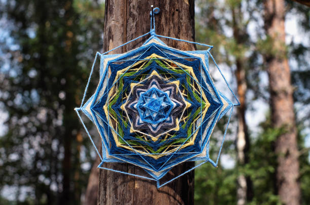 istock A mandala made of threads on a pillar. 2204076595