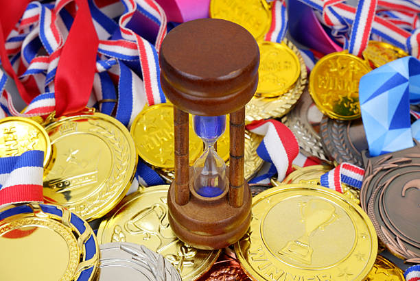 istock Hourglass on many medals background 2204076705