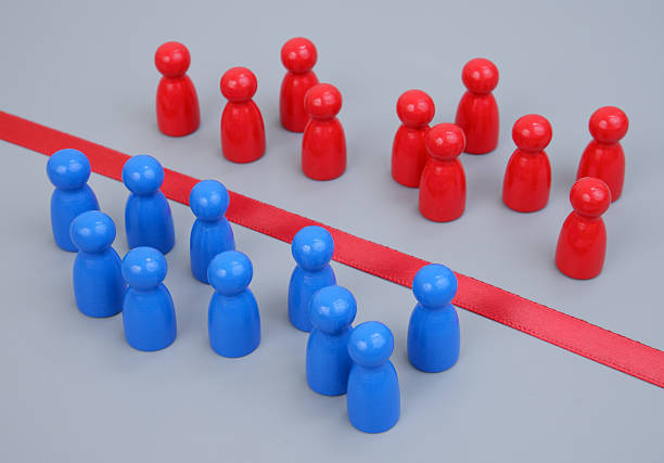 istock Groups of blue and red people figures separated by red line. 2204077228