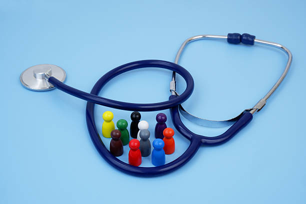 istock Group of colored people figures with stethoscope on blue background. 2204077288