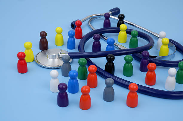istock Group of colored people figures with stethoscope on blue background. 2204077289