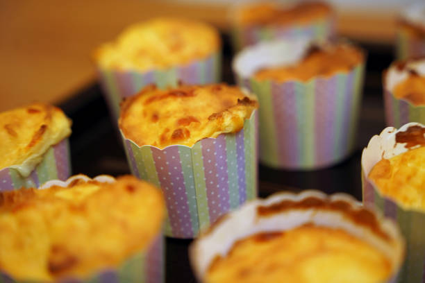 A delightful assortment of cupcakes is elegantly sitting on a black tray.