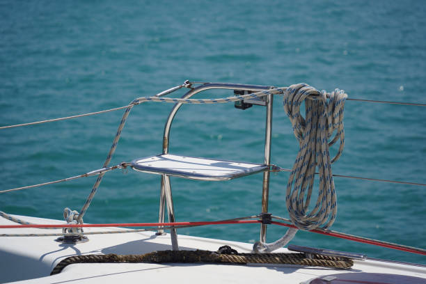 A white voyage boat featuring a steering wheel floating in the water.
