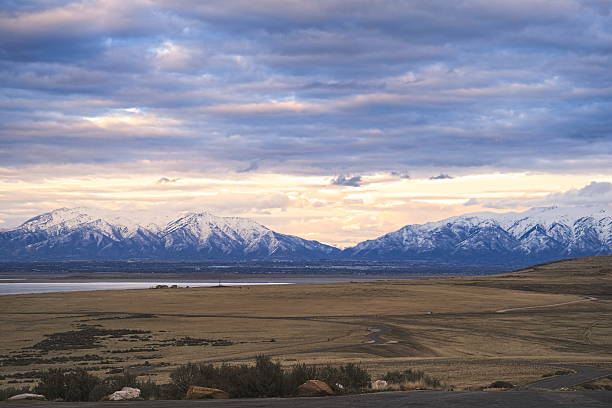 istock Serene Sunset Over Snow-Capped Mountains and Vast Open Plains 2204086998