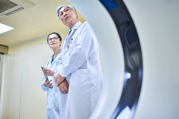 istock Two Asia Doctor Discussing & Examining at MRI-scanner Room 2204089013