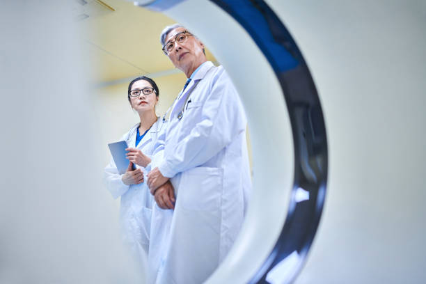 istock Two Asia Doctor Discussing & Examining at MRI-scanner Room 2204089100