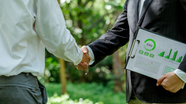 istock World Environment Day.ESG. business partner colleagues shaking hands working together in sustainable development goal. Sustainable business.Business value chain and Growing sustainability.CSR. 2204094592