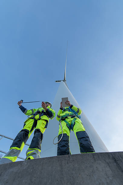 istock Wind Turbine Maintenance and Repair Technician, Engineer Checking Turbines working maintenance clean power generator system 2204094821