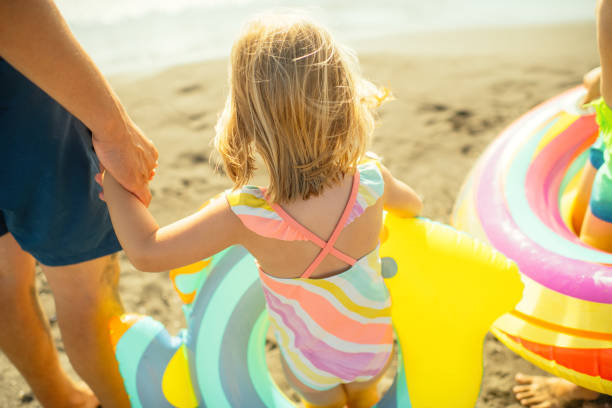 Father with children enjoying beach holidays
