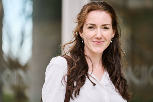 istock Smiling young businesswoman looking at camera outside 2204101068