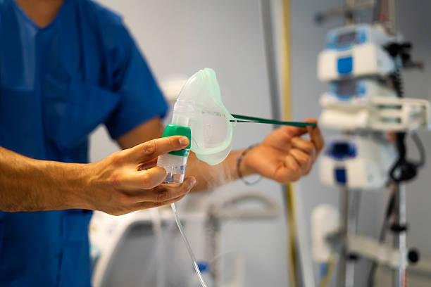 istock Doctor holding oxygen mask with nebulizer in hospital room 2204101737