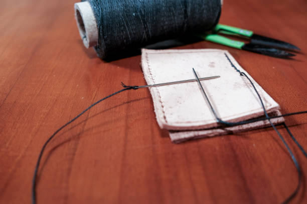Leather crafting tools for hand stitching on wooden table, Leather and the craft tools.