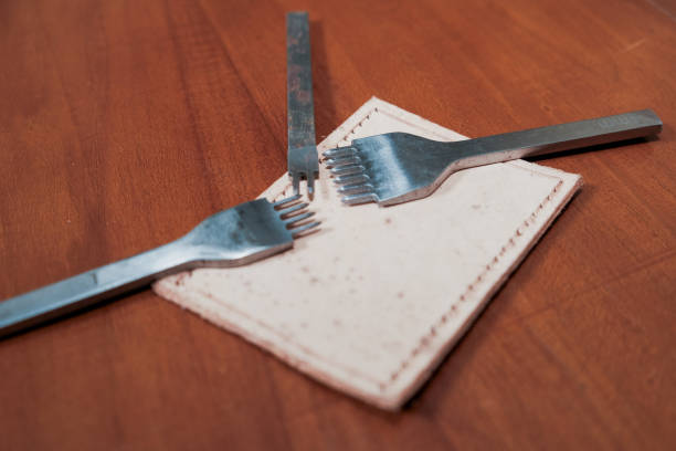 Leather crafting tools for hand stitching on wooden table, Leather and the craft tools.