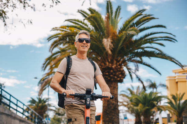 istock Adult man riding an electric scooter 2204102448