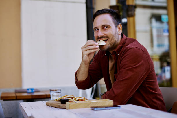 istock Businessman enjoying a quesadilla during his lunch break at a restaurant 2204104577