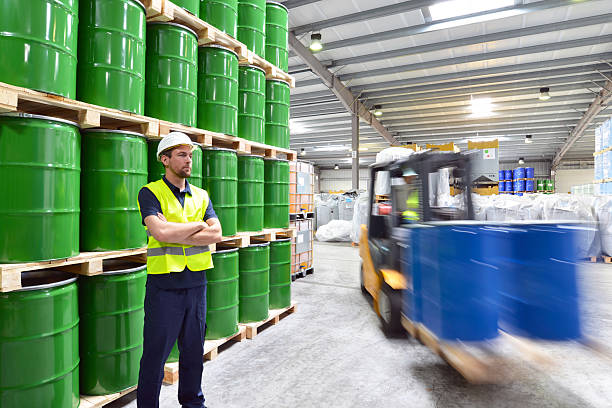 istock group of workers in the logistics industry work in a warehouse with chemicals 2204104840