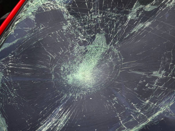 istock Shattered and broken windshield on a bright red car showcasing the damage to its glass surface 2204106372