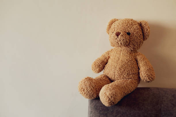 istock Brown teddy bear on the edge of the sofa 2204106776