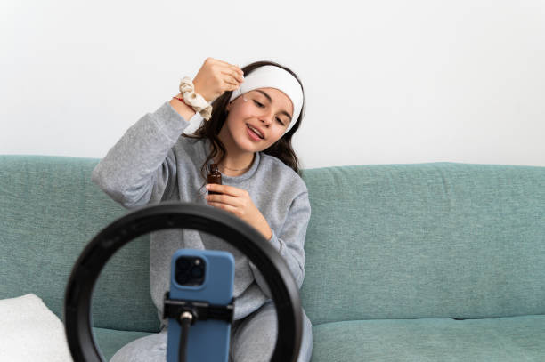 istock Teenager making a beauty tutorial video for social media using a ring light 2204106927